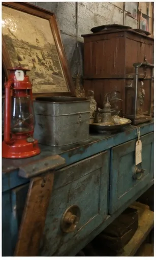 Red railroad lantern on a blue painted workbench